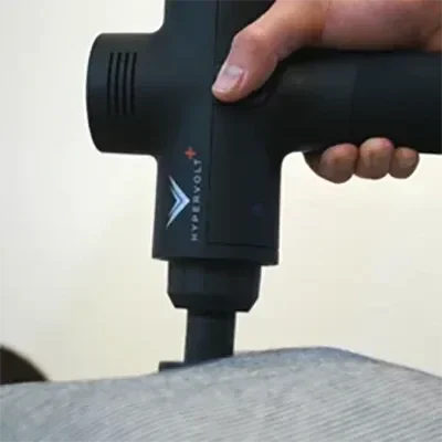 Percussion therapy being performed on a patient's back